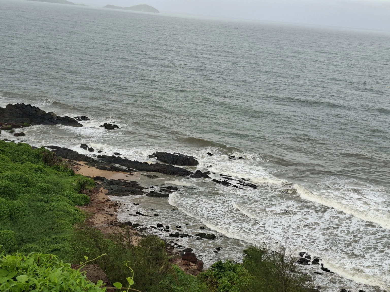 Rocky coastline and waves below Japanese Garden