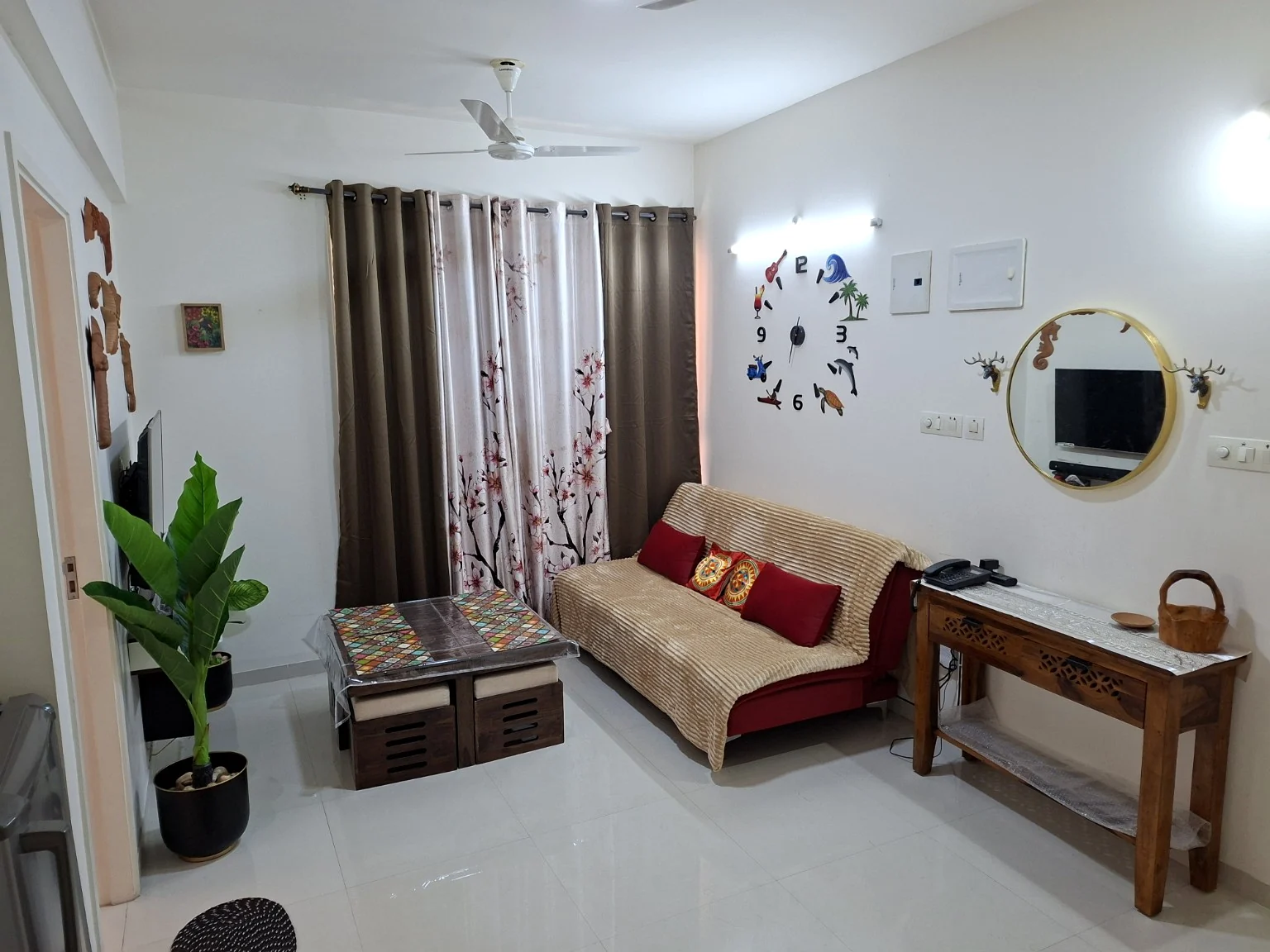 The living room with its sofa, patterned table and personal decorative touches