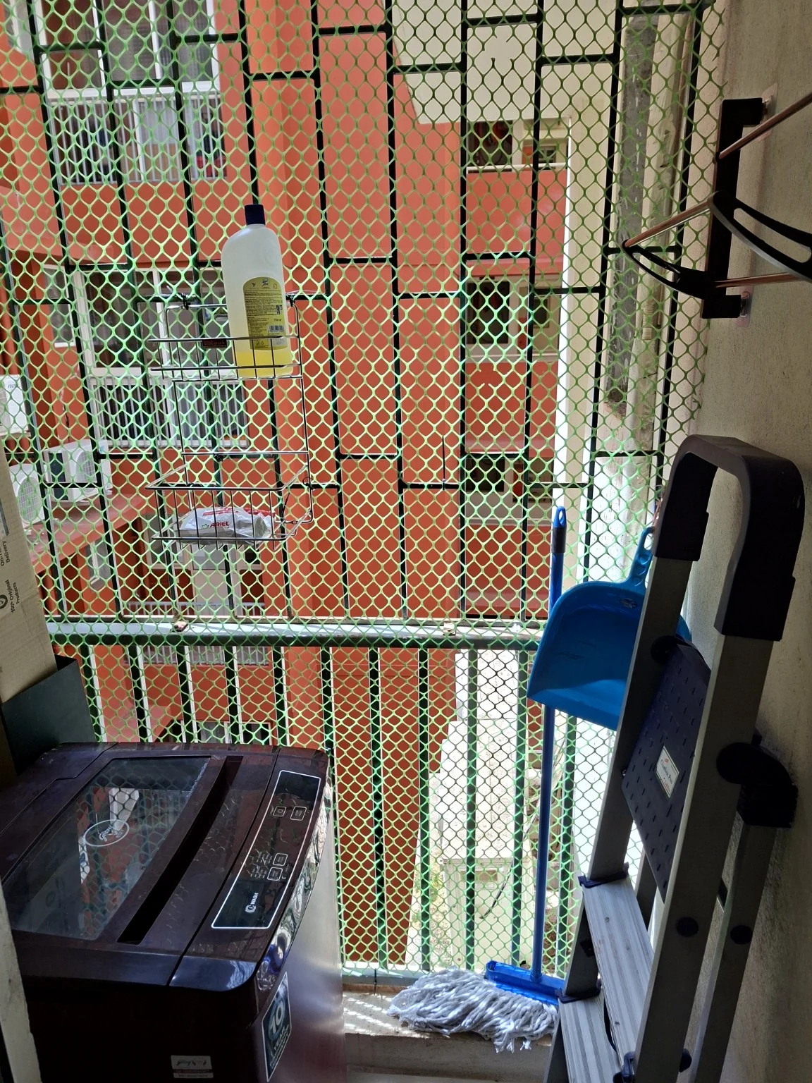 Washing machine, drying rack and laundry essentials on the utility balcony